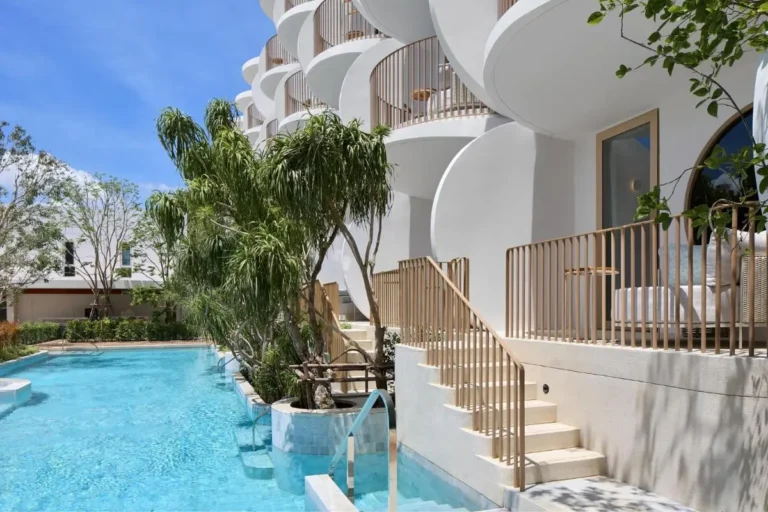 Modern Outdoor Pool Area with Rounded Balconies and Natural Landscaping at Panwa Beach