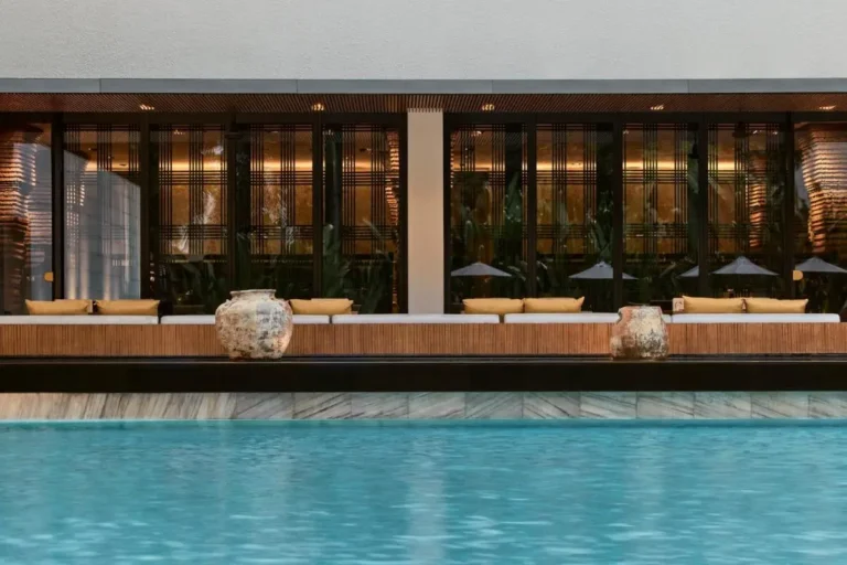 Modern Outdoor Pool Area with Seating and Large Glass Windows in Sathorn Bangkok