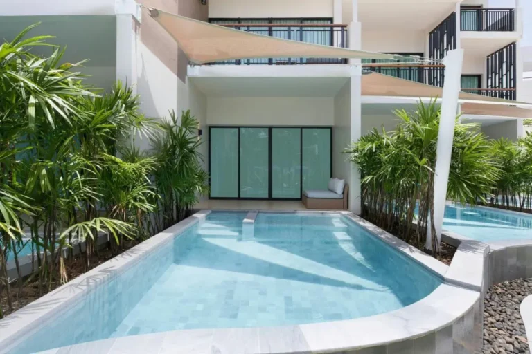 Modern Outdoor Pool Area with Shade Sails and Greenery at Mai Khao Beach
