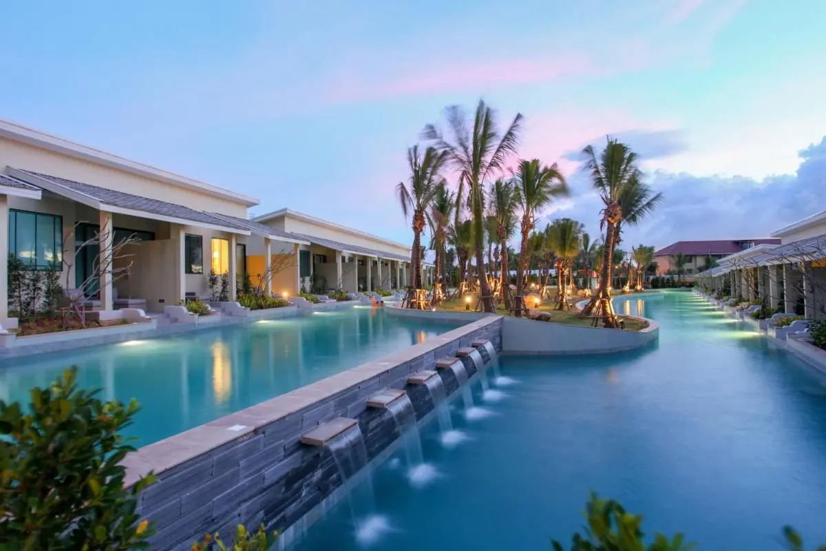 Modern Outdoor Pool Area with Waterfall and Palm Trees in Phuket Town
