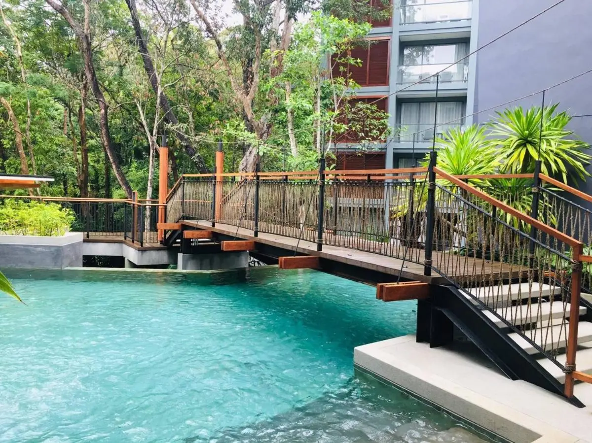 The Nature Phuket Modern Outdoor Pool Area with Wooden Bridge and Tropical Surroundings at Patong Beach