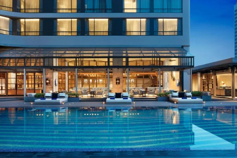 Modern Outdoor Swimming Pool and Lounge Area with Tiled Deck in Khlong Toei
