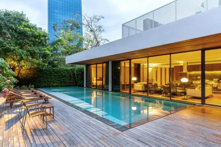 Modern Outdoor Swimming Pool and Lounge Area with Urban Skyline in Sathorn Bangkok