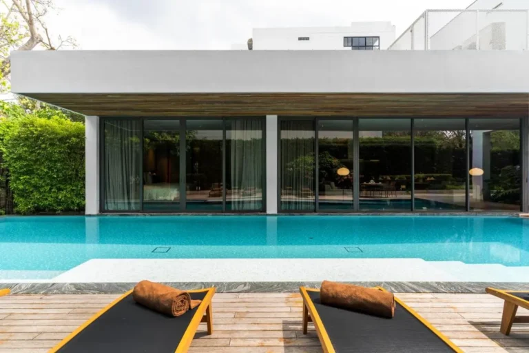 Modern Outdoor Swimming Pool and Relaxation Area with Lounge Chairs in Sathorn Bangkok