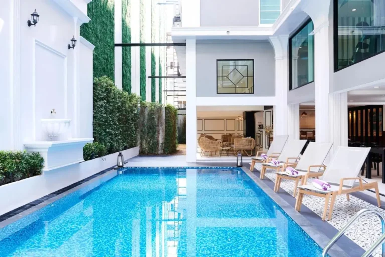 Modern Outdoor Swimming Pool and Relaxation Area with Lounge Seating in Phra Nakhon