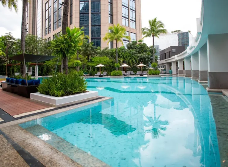 Modern Outdoor Swimming Pool and Relaxation Area with Tropical Landscaping in Khlong Toei Bangkok