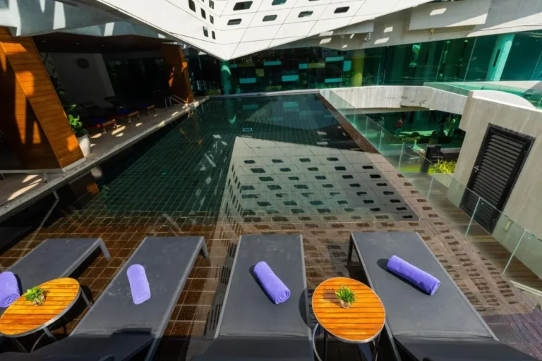 Modern Outdoor Swimming Pool and Wellness Area with Loungers in Pathumwan Bangkok