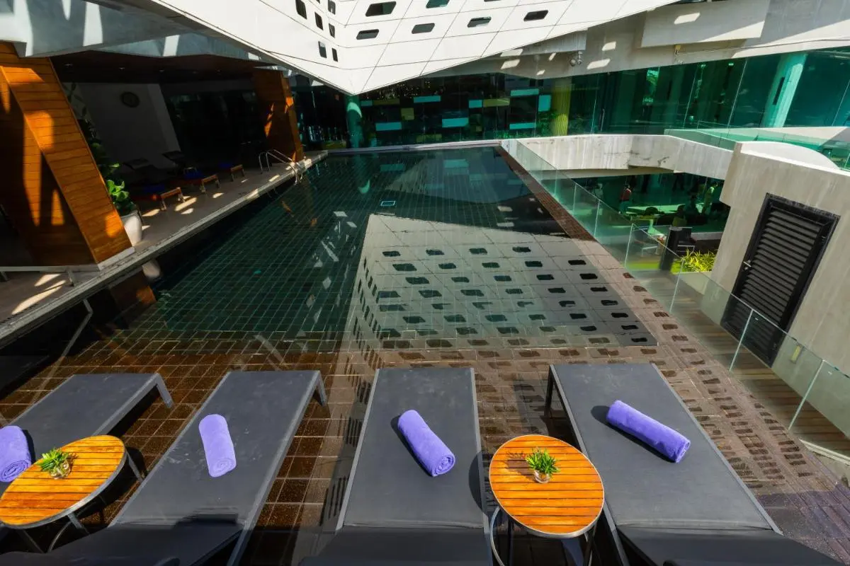 LiT BANGKOK Hotel Modern Outdoor Swimming Pool and Wellness Area with Loungers in Pathumwan Bangkok