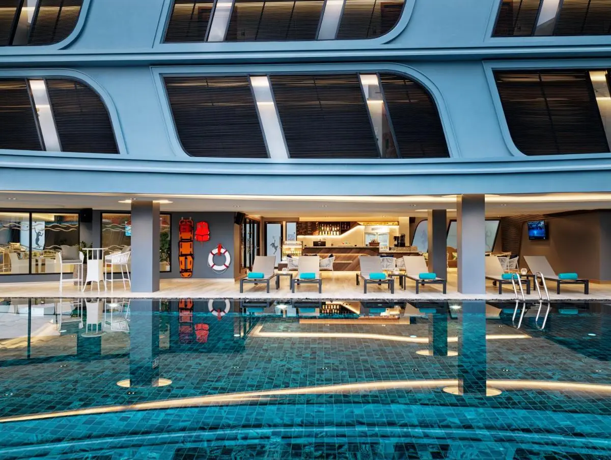The Oceanic Sportel Phuket - SHA Extra Plus Modern Outdoor Swimming Pool Area with Lounge Chairs and Covered Seating in Phuket Town Thailand