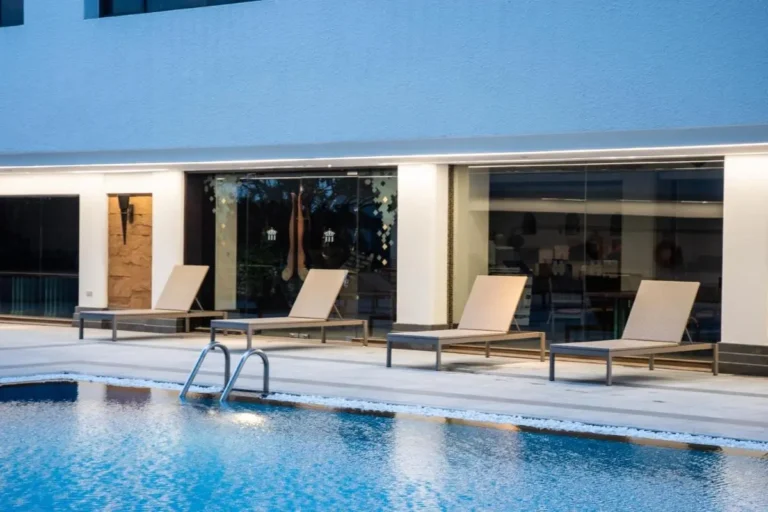 Modern Outdoor Swimming Pool Area with Lounge Chairs in Pathumwan Bangkok
