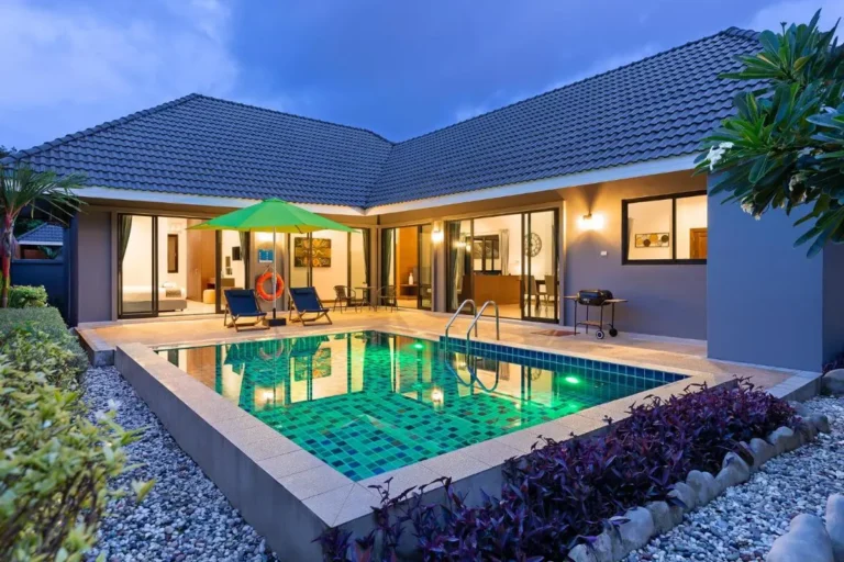 Modern Outdoor Swimming Pool Area with Lounge Seating and Patio Umbrella at Rawai Beach
