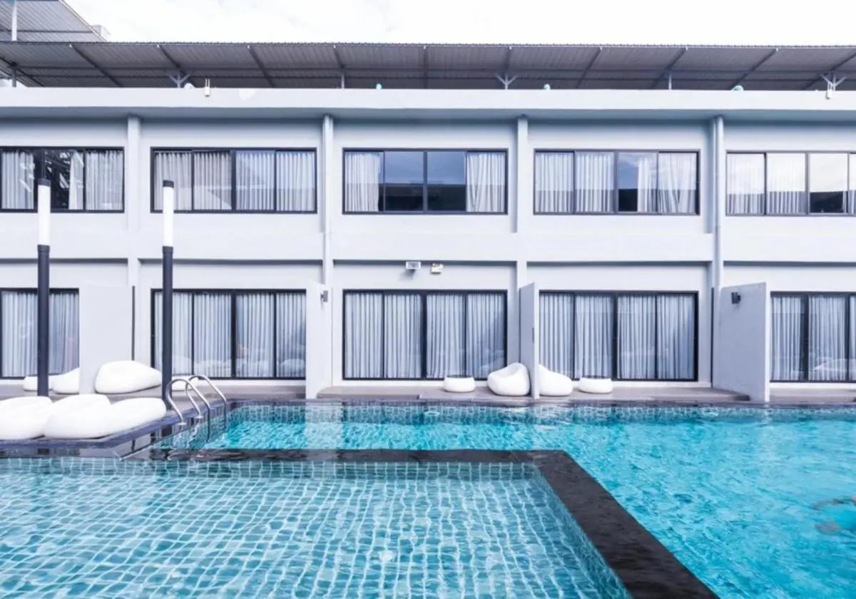 Modern Outdoor Swimming Pool Area with Lounge Seating in Huai Khwang Bangkok