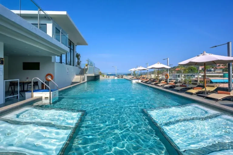 Modern Outdoor Swimming Pool with Jacuzzi Areas and Ocean View at Patong Beach