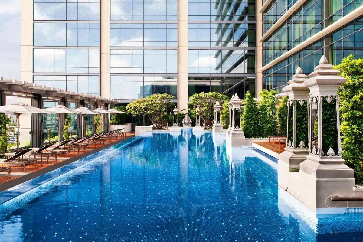 Modern Outdoor Swimming Pool with Lounge Area and Urban Views in Pathumwan Bangkok