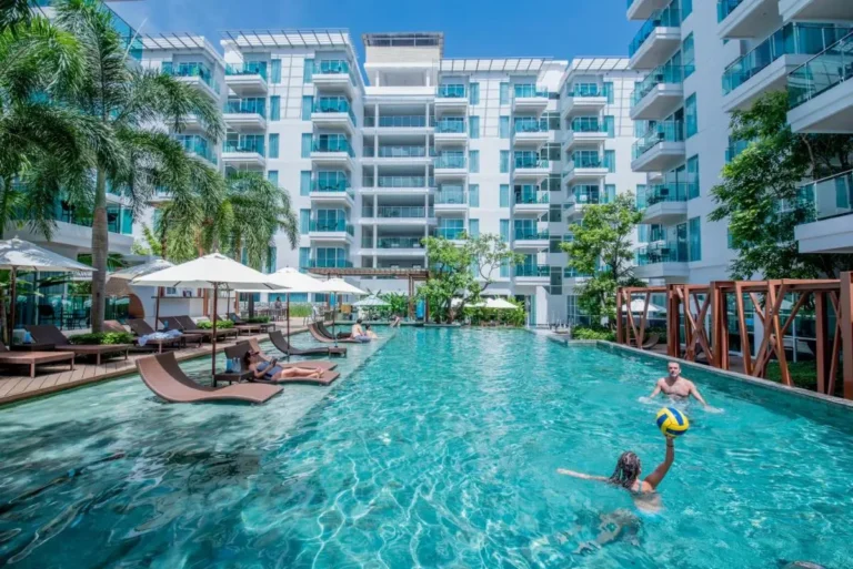 Modern Outdoor Swimming Pool with Lounge Chairs and Cabanas at Patong Beach