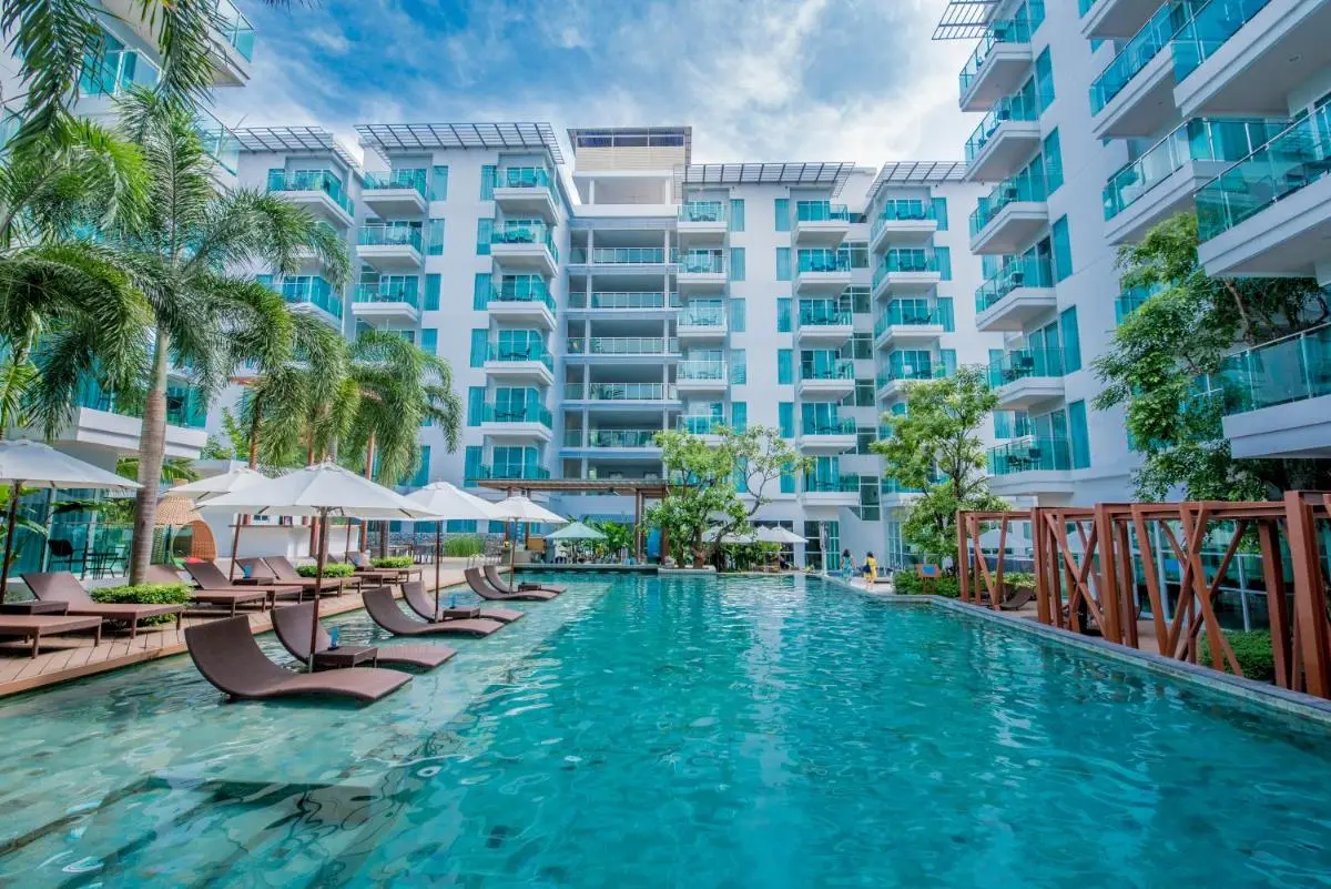 Modern Outdoor Swimming Pool with Lounge Chairs and Umbrellas at Patong Beach