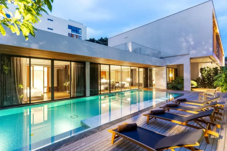 Modern Outdoor Swimming Pool with Lounge Chairs and Wooden Deck in Sathorn Area