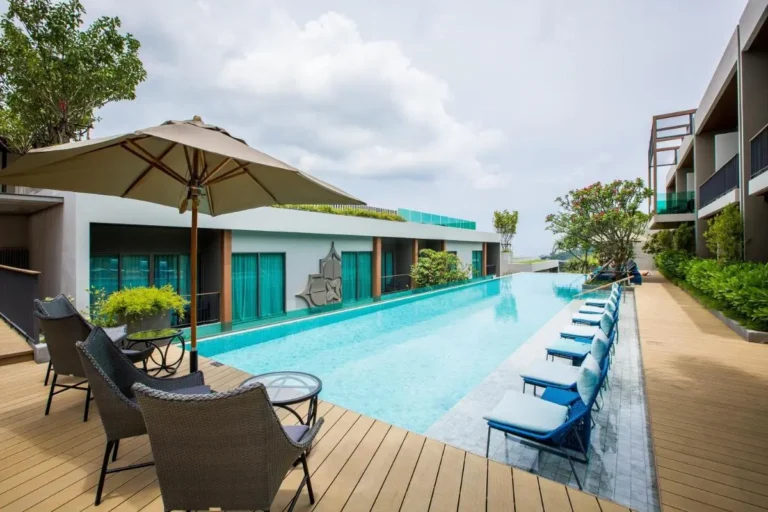 Modern Outdoor Swimming Pool with Lounge Seating and Elevated Views at Patong Beach