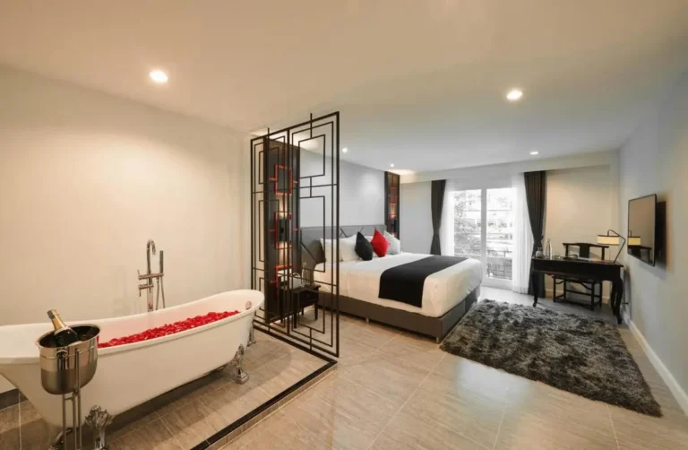 Modern Phra Nakhon Suite Featuring Freestanding Clawfoot Bathtub with Rose Petals and Champagne