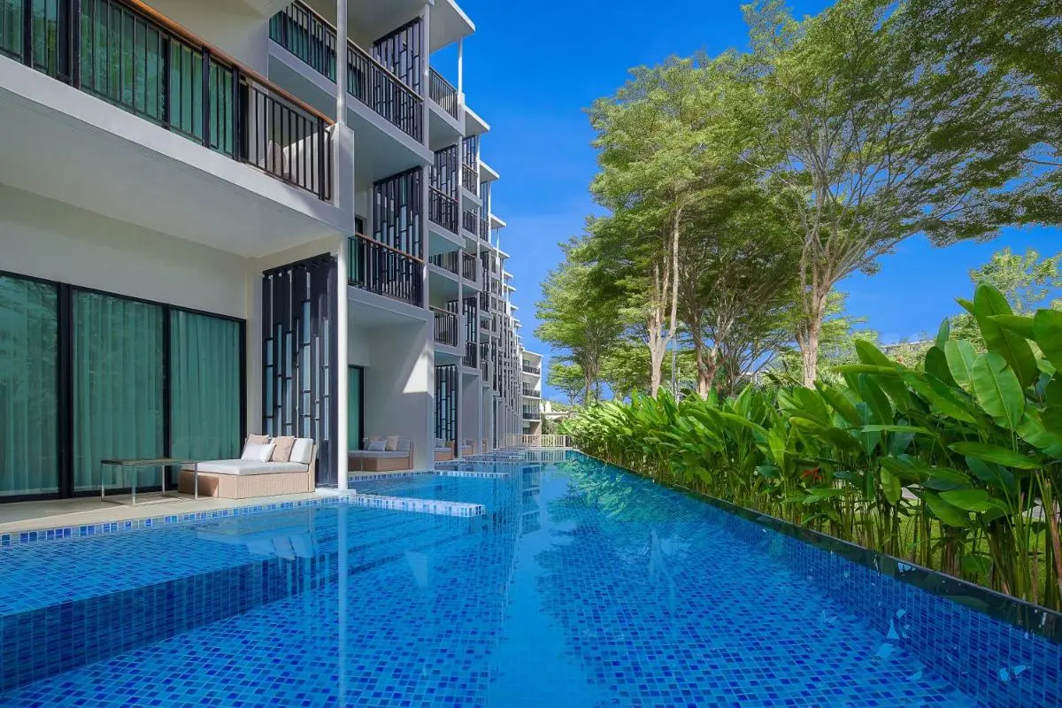 Modern Residential Building with Long Narrow Swimming Pool and Lounge Area at Mai Khao Beach