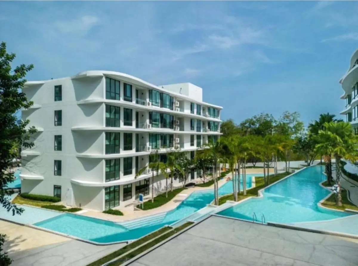Modern Residential Complex with Curved Architecture and Expansive Swimming Pool at Rawai Beach