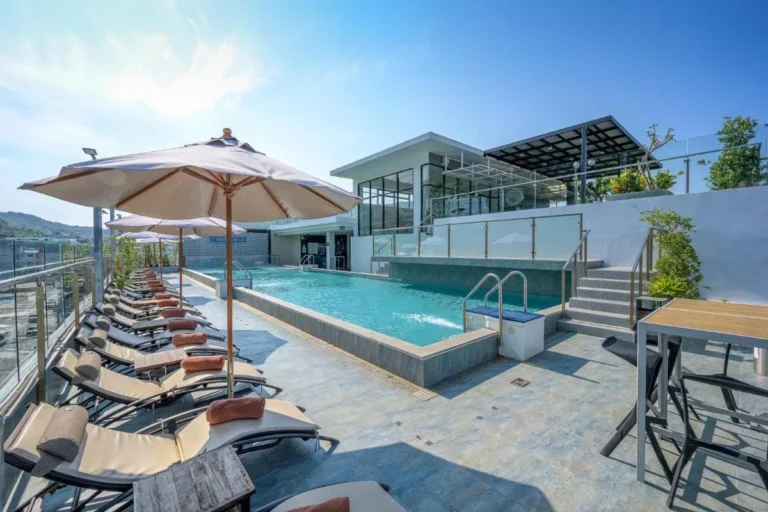 Modern Rooftop Pool Area with Lounge Chairs and Scenic Views at Patong Beach