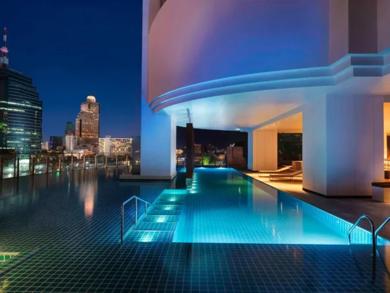 Modern Rooftop Swimming Pool and Lounge Area with City Views in Khlong San Bangkok