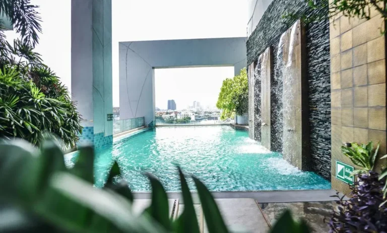 Modern Rooftop Swimming Pool with Waterfall Features and City Views in Bang Kho Laem
