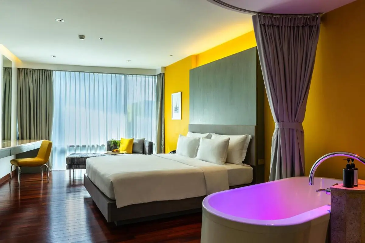 LiT BANGKOK Hotel Modern Room with Illuminated Freestanding Bathtub and Large Window in Pathumwan