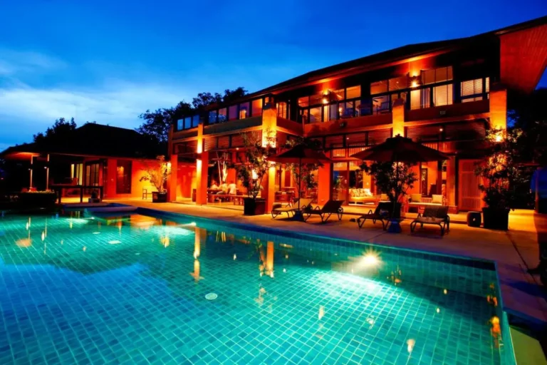 Modern Two-Story Building with Illuminated Swimming Pool and Relaxation Area at Panwa Beach
