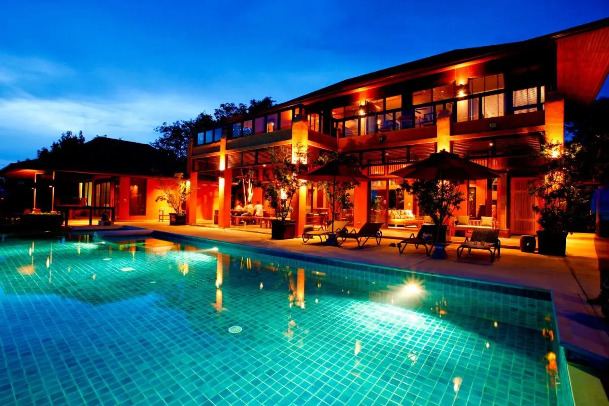 Modern Two-Story Building with Illuminated Swimming Pool and Relaxation Area at Panwa Beach