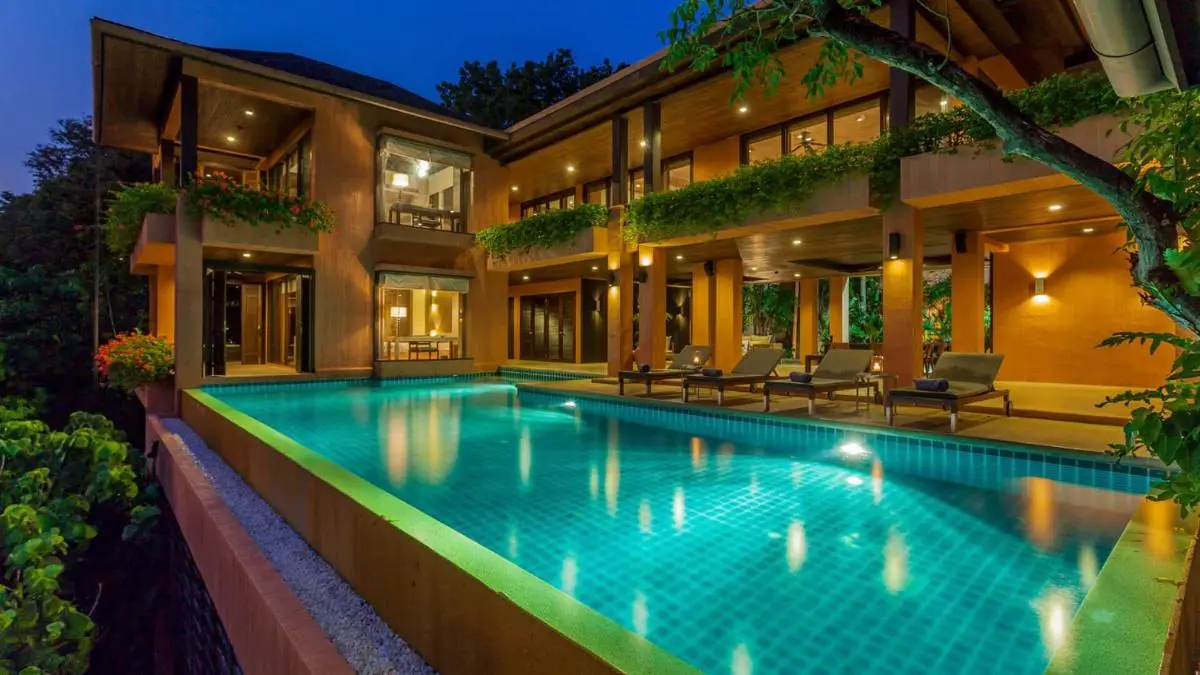 Modern Two-Story Home with Illuminated Swimming Pool and Relaxing Outdoor Lounge at Panwa Beach