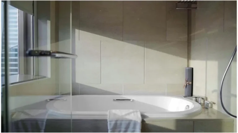 Modern Urban Bathroom with Built-In Oval Bathtub and Natural Light in Pathumwan