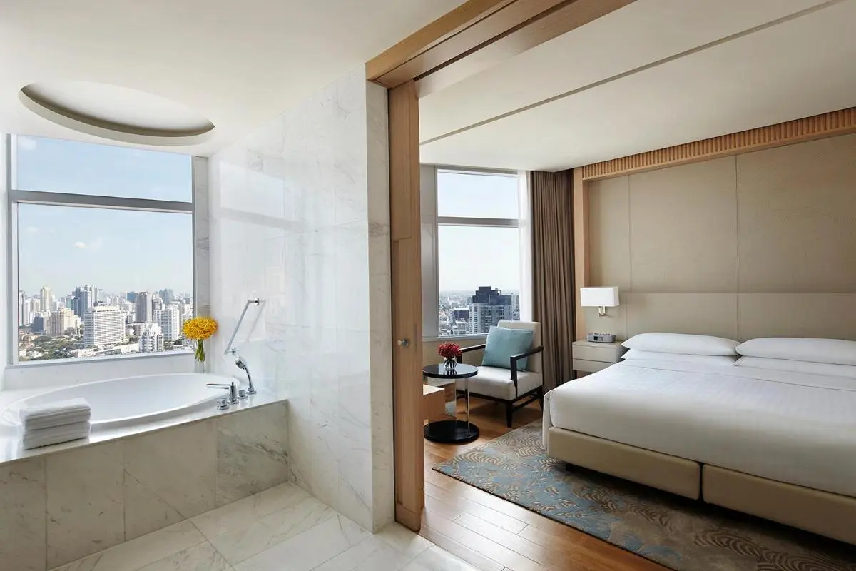 Bangkok Modern Wattana Hotel Room Featuring Large Oval Bathtub with City Views