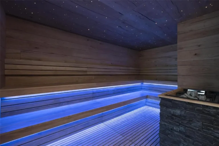 Modern Wooden Sauna Room with Blue LED Lighting and Stone Heater in Pathumwan