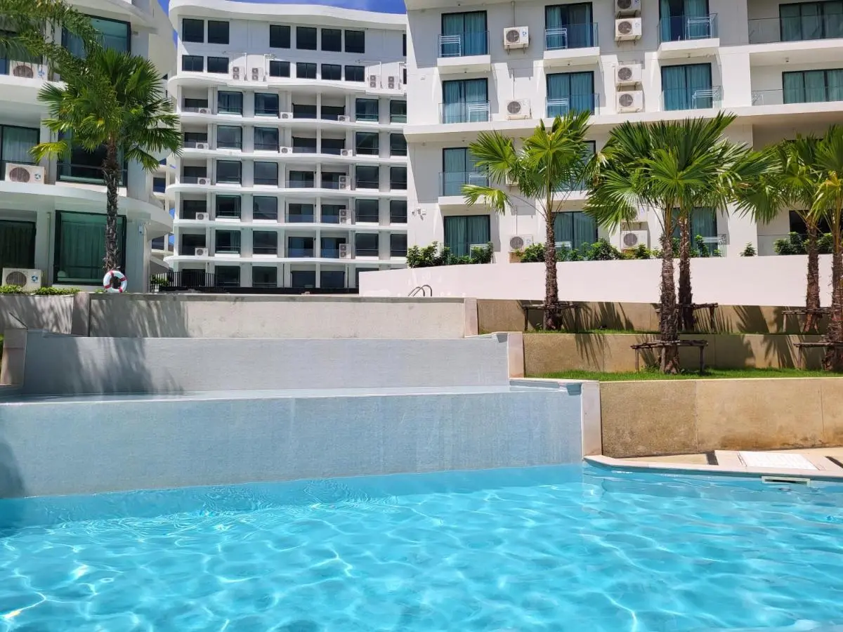 Multi-Level Outdoor Swimming Pool with Palm Trees at Rawai Beach Residential Complex