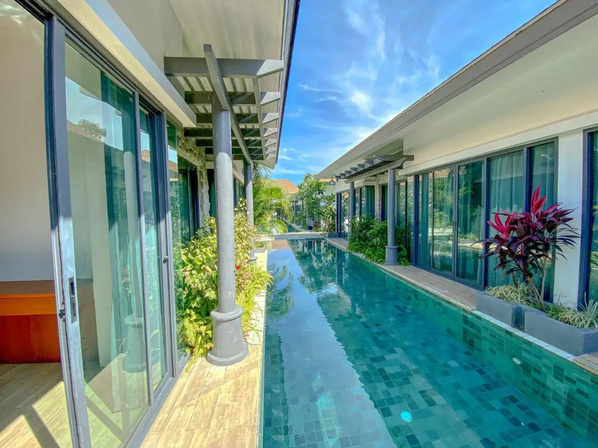 Tajh Pool Villas Narrow Rectangular Swimming Pool Between Two Single-Story Buildings with Pergola Awnings Phuket Province