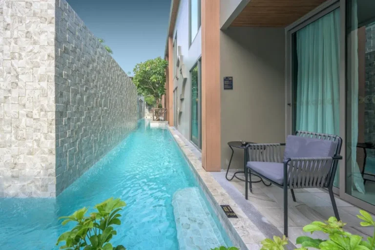Narrow Swimming Pool with Stone Wall and Modern Building at Patong Beach