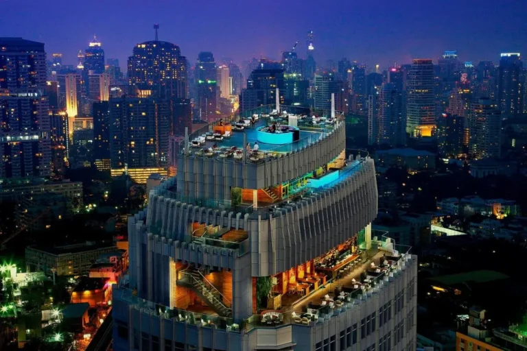 Night View of High-Rise Building with Outdoor Pools and Terraces in Wattana Bangkok
