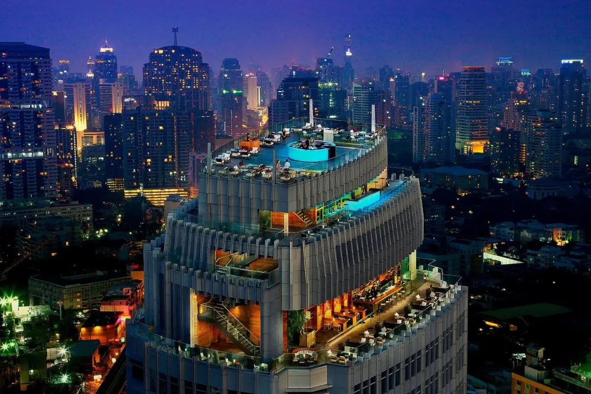 Night View of High-Rise Building with Outdoor Pools and Terraces in Wattana Bangkok