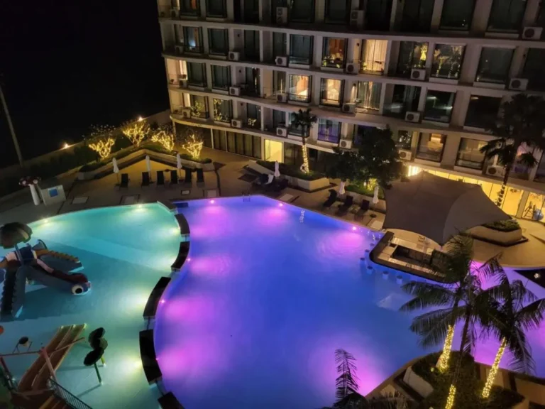 Nighttime Multi-Level Outdoor Pool Area with Illuminated Water Features in Rawai Beach