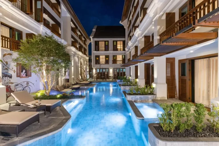 Nighttime View of Illuminated Outdoor Swimming Pool Between Buildings in Chiang Mai