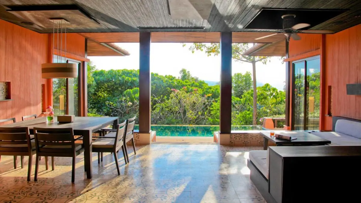 Open-Plan Indoor-Outdoor Living Space with Rectangular Pool and Garden View at Panwa Beach