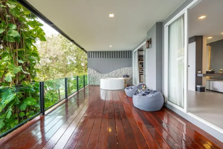 Outdoor Balcony with Soaking Tub and Relaxing Seating Overlooking Greenery at Karon Beach