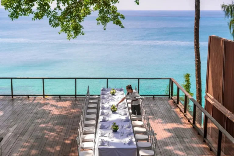 Outdoor Dining Area Overlooking Calm Ocean Waters at Nai Thon Beach
