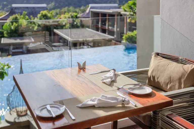 Outdoor Dining Area Overlooking Infinity Pool with Scenic Mountain Views at Patong Beach
