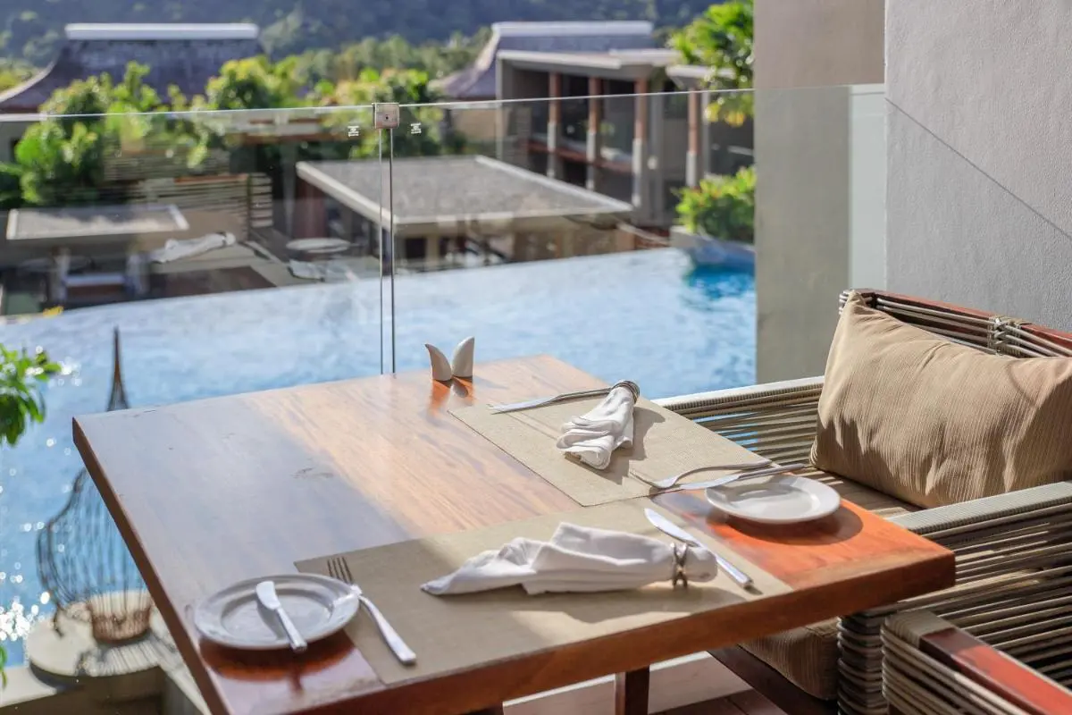 Outdoor Dining Area Overlooking Infinity Pool with Scenic Mountain Views at Patong Beach