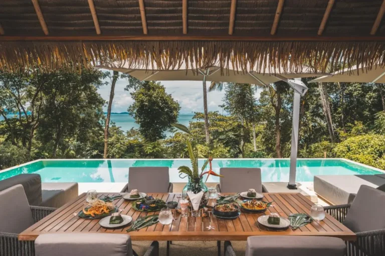 Outdoor Dining Area with Infinity Pool Overlooking Coastal Views in Phuket Town