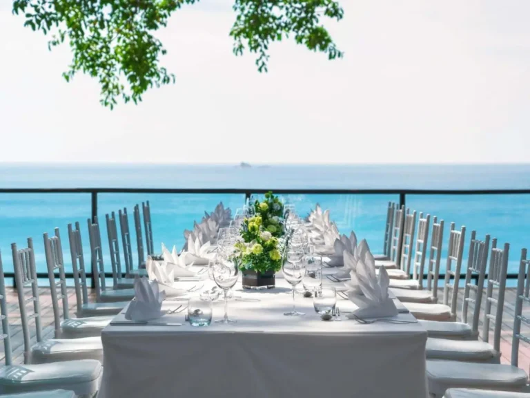 Outdoor Dining Setup with Ocean View and Glass Railing at Nai Thon Beach