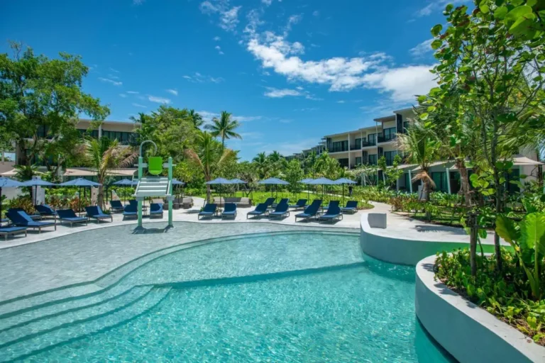Outdoor Freeform Pool Area with Lounge Chairs and Children’s Splash Zone at Mai Khao Beach